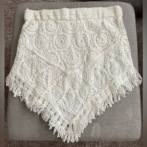 Crochet mini skirt with fringe accent.
